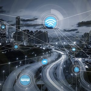 Imagem representa uma cidade com vários icones de conectividade interligados